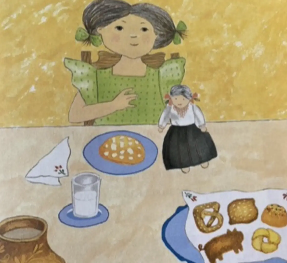 A girl sitting at the table with food on it